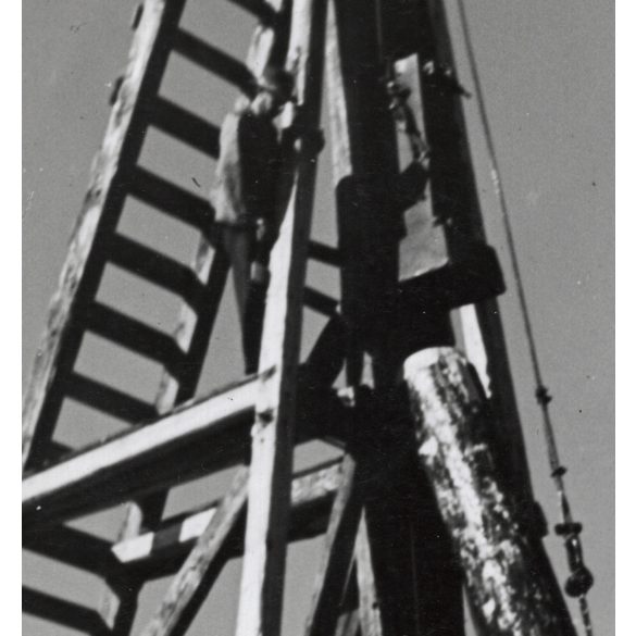 Nagyobb méret, Szendrő István fotóművészeti alkotása, hidak építéséhez használt cölöpverő, háttérben a Halászbástya (Kossuth híd építése?) Budapest, építkezés, emberek, 1940-es évek. 